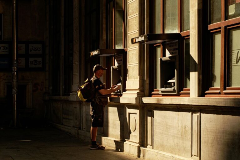 Man using outdoor ATM representing banking choices