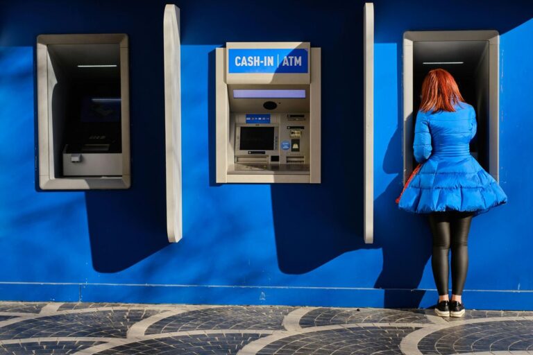 Woman at bank ATM representing home equity borrowing options
