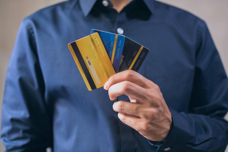 Man holding multiple credit cards comparing balance transfer offers